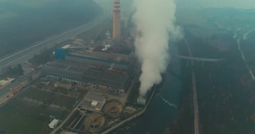 Abstract Aerial View of Coal Power Plant High Pipes with Black Smoke Moving Up Polluting Atmosphere