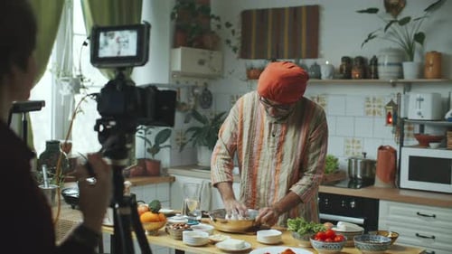 Chef Cooking in Kitchen Being Filmed