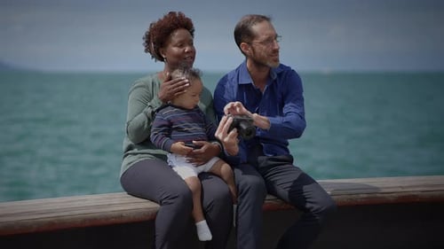 Family with Baby Enjoying Day by the Ocean