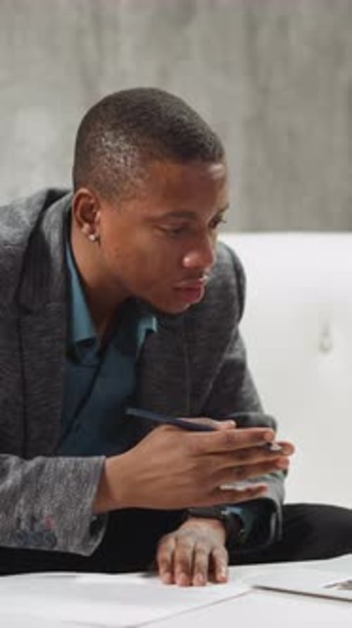 Young Adult Writing on Paper at Desk Indoors