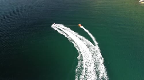 Jet Ski Pulling Tube on Emerald Water