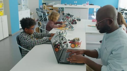 Children Learning Coding and Robotics in Classroom