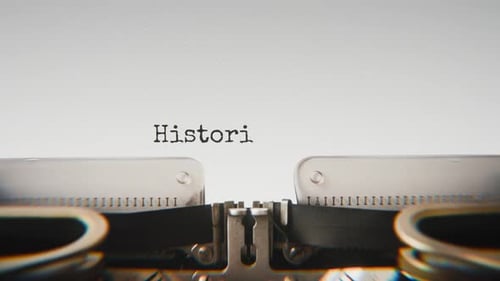 Old mechanical typewriter typing Historic Discoveries in a close-up view.