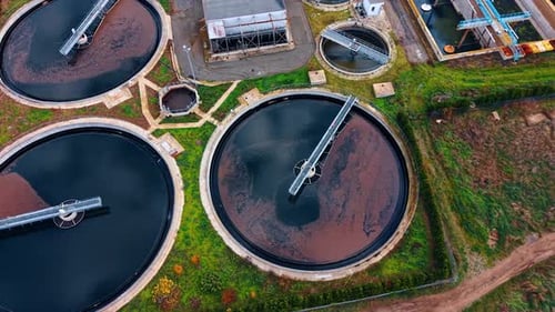 Sewage water filling the round reservoirs at the territory of modern water treatment plant.