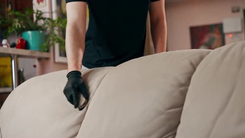 Close Up Professional Cleaning in an Apartment the Cleaner Cleans a Textile Sofa with a Brush and