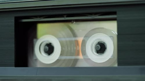Rotating Reels of a VHS Tape in Player
