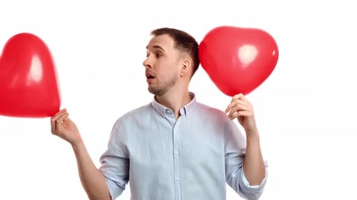Happy Man Holding Two Red Heart Balloons