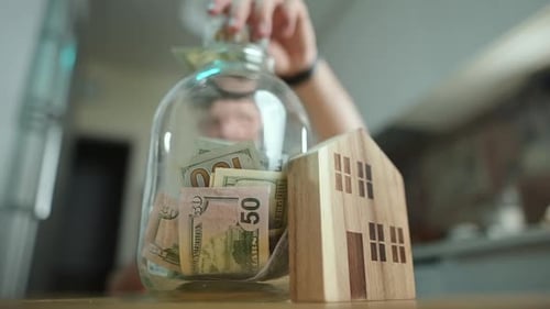Saving Money in Jar for Real Estate