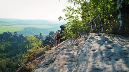 Young Adult Hiker Walking Down Rocky Terrain