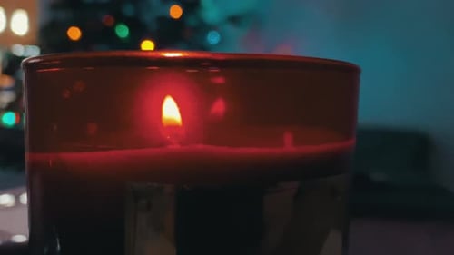 Burning Candle by Christmas Tree for Holidays