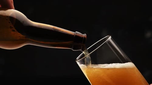 Pouring Beer From Bottle Into Glass