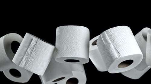Floating White Toilet Paper Rolls on Black Background