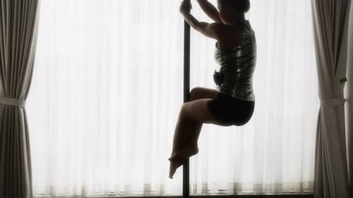 Woman Doing Pole Dancing in Living Room