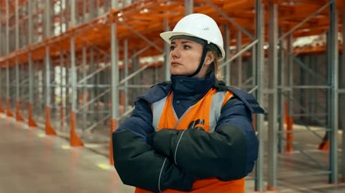 Warehouse Worker Stands Strong in Factory Interior