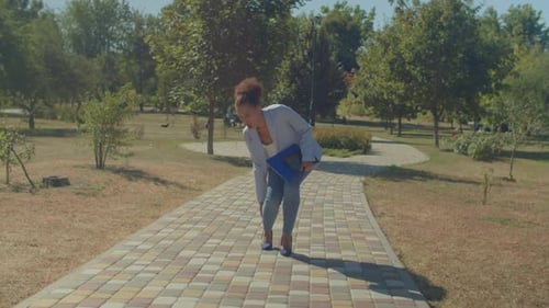 Lovely Black Female in High Heels Having Ankle Sprain During Walk Outdoors
