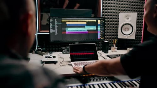 recording studio sound engineer producer mixes songs on screen colorful audio tracks professional