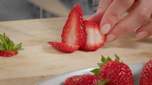 Close-up Of Woman Hands Slicing Strawberries