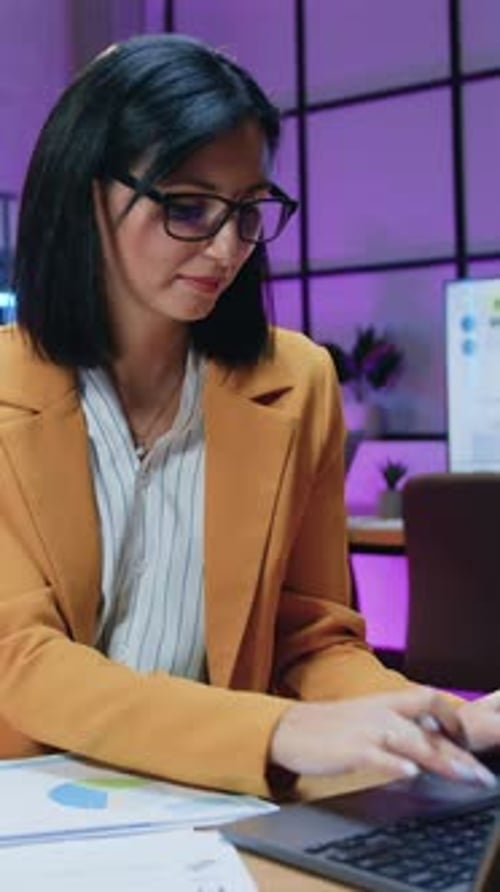 Woman Working at Desk in Office with Laptop