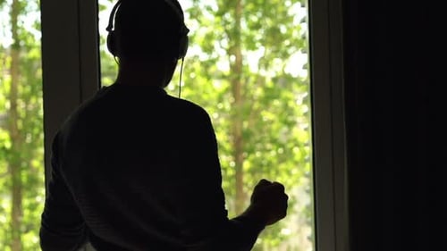 Man Listening to Music and Dancing at Home