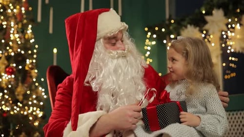 Child Receives Christmas Gift from Santa Claus