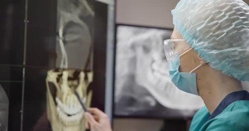Radiologist Dentist Doctor Looking at Teeth 3D Xray On Desktop Computer Monitor