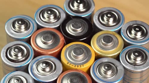 Rows of used alkaline AA batteries. Lithium ion battery pack close up. Electric power supply