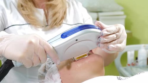 Skin Care Aesthetic Procedure in Modern Cosmetology Clinic Expert Beautician Using Phototherapy