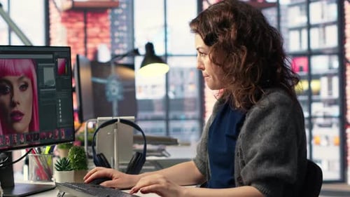 Woman Editing a Photo on Computer in Office