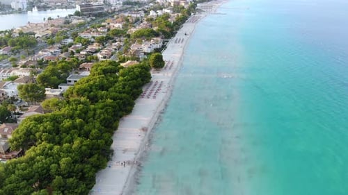 Aerial Panorama View Over Beach With Lush Turquoise Ocean Waves Crashing. Slow Tilt Down