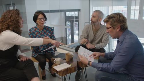 Business Team Discussing Documents at Workplace Meeting