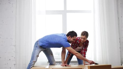 Couple opening shipping box together in home