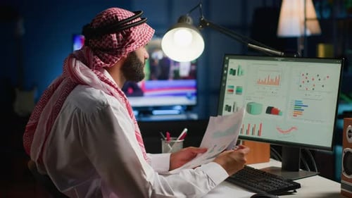 Man Analyzes Data at Desk in Urban Workplace