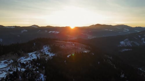 Aerial View Golden Winter Sunset Over Mountain Valley Stunning Sunset Over a Snowdusted Mountain