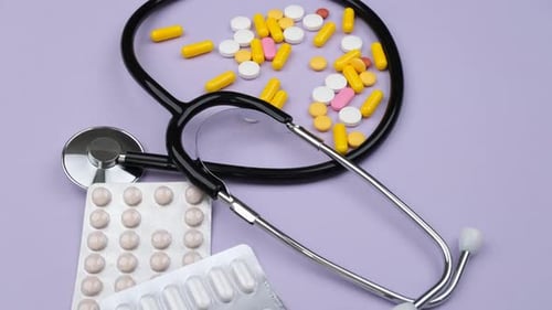 Medical Pills and Stethoscope Overhead Close Up