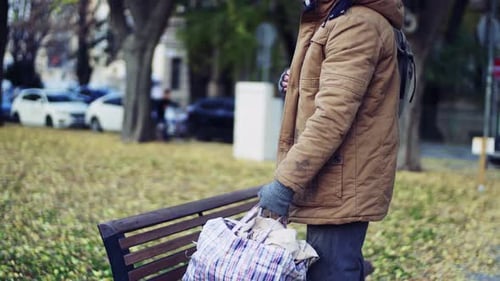 Homeless Beggar Man Walking Outdoors in Park