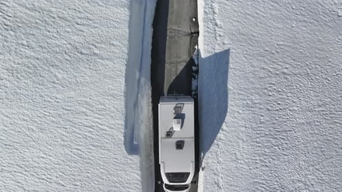 Motorhome Driving Through a Snow Corridor in Norway