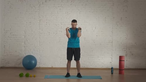 Man Fitness Instructor in Sportswear Doing an Upper Body Warm Up for Online Class at His Home Studio