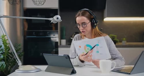 Businesswoman call center customer service support agent wear headset talking looking at laptop hold