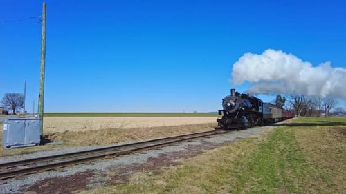 Classic Steam Locomotive Under Wide Blue Skies in Rural Pennsylvania