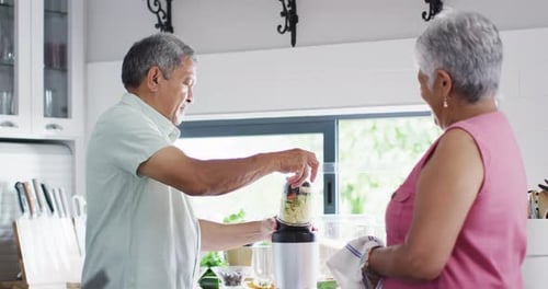 Senior Couple Making Healthy Smoothie in Bright Kitchen
