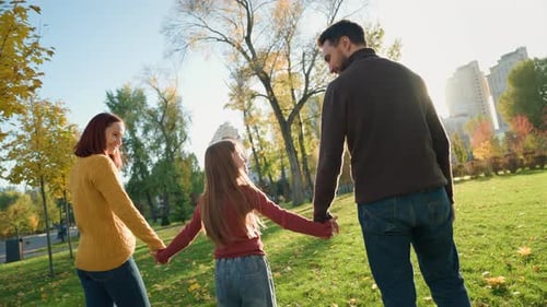 Happy Family in Park Back View Woman Mother Father Man Standing Outdoors Little Girl Kid Child