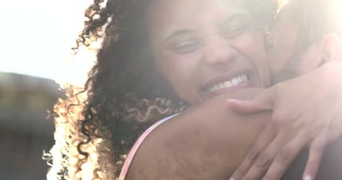 Smiling Couple Embraces in Bright Sunlight