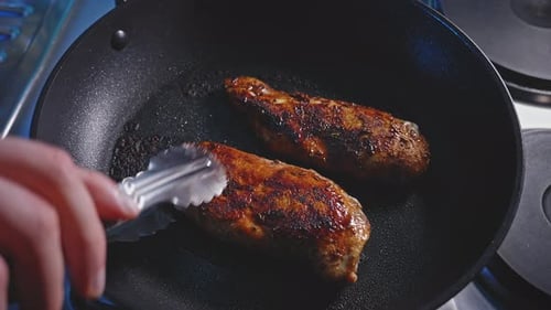 Frying Meat in Pan on Stove
