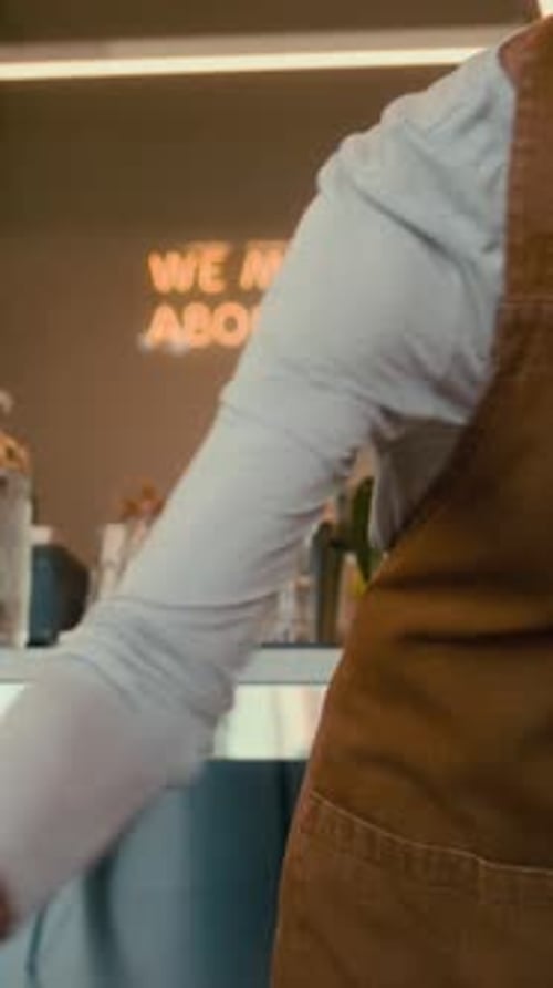 Mature Waitress Cleaning Cafe Tables