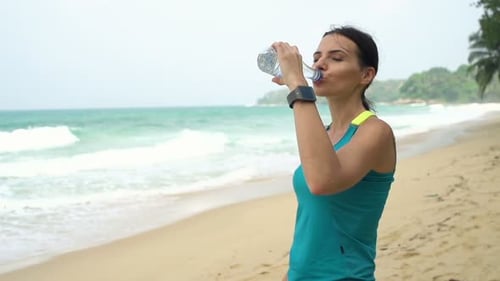 Sporty Woman Drinking Water After Workout on Beach, Super 240