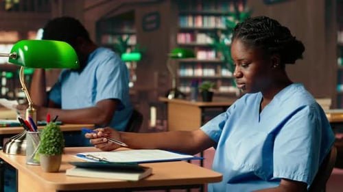 African American Med School Pupil Studies Pharmacology Notes in a Library