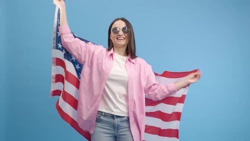 Woman Smiles and Dances with American Flag