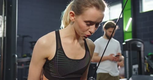 Portrait View of the Strong Healthy Tired Women Doing Push Ups While Training Arms with Trx Fitness