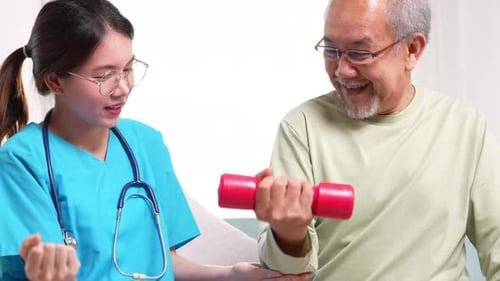 Nurse Helping Senior Patient with Exercise at Home