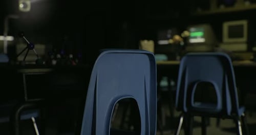 Empty Classroom with Blue Chairs and Dim Lighting at Twilight